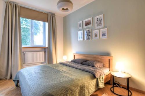 a bedroom with a large bed and a window at Serene 1BR with Sauna & Private Entrance in Tallinn