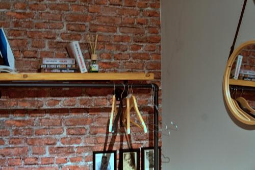 a shelf on a brick wall with a mirror at Industrial Style 77qm mit Balkon in Herne