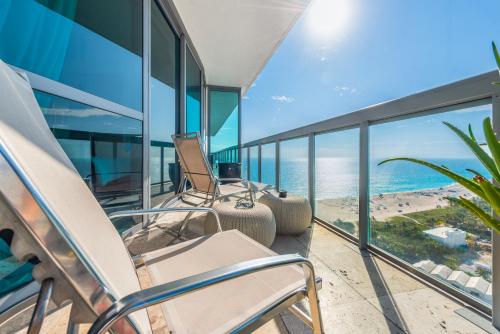 a balcony with chairs and a view of the ocean at THE SETAI 5 STARS HOTEL-RESIDENCE MIAMI BEACH OCEANVIEW 2 Bedroom UNIQUE in Miami Beach