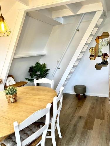 a dining room with a wooden table and stairs at Chalet 190 La Belle Durbuy in Durbuy