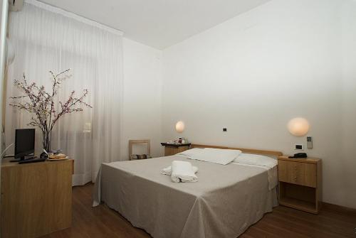 a bedroom with a bed with two towels on it at Hotel Mediterraneo in Chianciano Terme