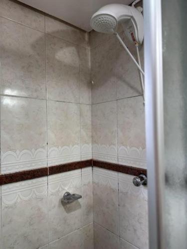 a shower with a shower head in a bathroom at Condall Palace Hotel in Nova Prata