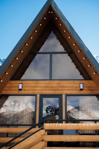 a view of the front of a house with windows at SMART Via Kazbegi in Stepantsminda