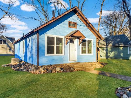 a blue tiny house in a yard at Okoboji BLUEtiful Cottage in Arnolds Park