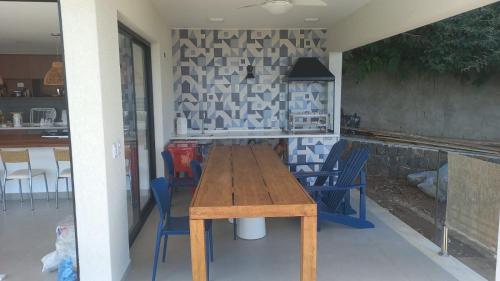 a wooden table and chairs on a patio at Casa estrada da torre in Ilhabela