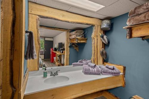 a bathroom with a sink and a mirror at Stonegate Lodge 2mi to Historic DTWN Pool WiFi 2 Queen Beds Room #210 in Eureka Springs