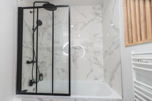 a shower with a glass door in a bathroom at LE FACTORY aux pieds de la gare SNCF Laval in Laval