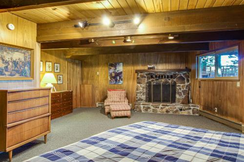 a bedroom with a bed and a stone fireplace at Donner Lakefront Retreat in Truckee