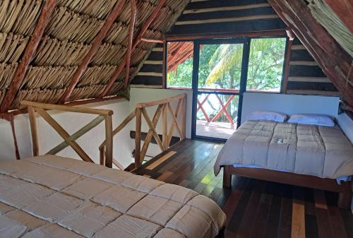 a bedroom with two beds in a attic at Xanthus Hotel in Huay Pix