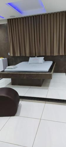 a room with two beds and a table with a mattress at PALACE RECANTO DAS EMAS in Brasília