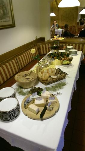 a long table with plates and food on it at Hotel Alpenfrieden in Rio Bianco