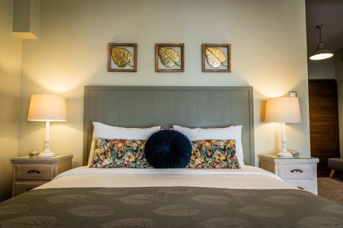 a bedroom with a large bed with two lamps at MARON ΙΙ με τζάκι in Kalavrita
