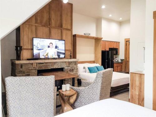 a living room with a fireplace and a television at Hyatt Main Street Station 3BD B - Steps to Peak 9 in Breckenridge