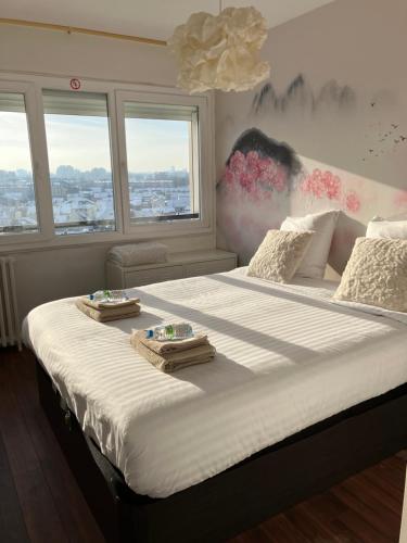 - un grand lit avec 2 serviettes dans l'établissement Kastel, à Maisons-Alfort