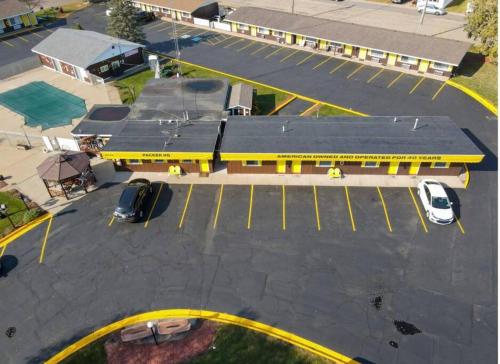 an overhead view of a yellow building with a parking lot at #17 Snooze in Wisconsin Rapids