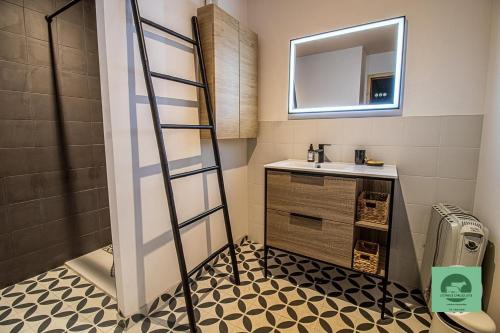 a bathroom with a sink and a mirror at L’étable d’Auguste in Arreau