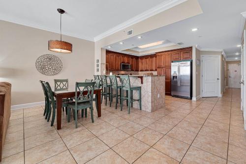 an open kitchen and dining room with a table and chairs at Phoenix Gulf Shores 2102 in Gulf Shores