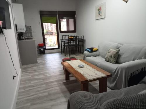 a living room with a couch and a coffee table at Casa Cefita in Madroñal