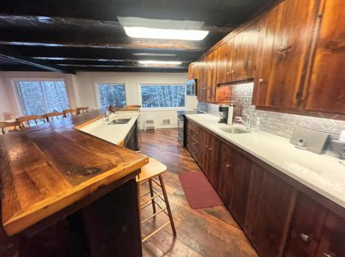 a large kitchen with wooden cabinets and a wooden floor at The Boshrock in Carnarvon