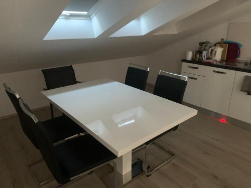 a white table and chairs in a room at Tom's House Njivice in Njivice