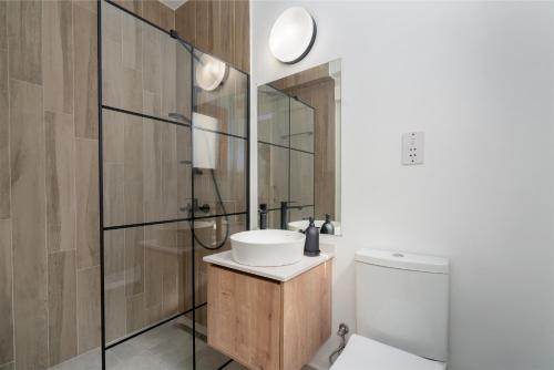 Un baño con inodoro, lavabo y ducha. en Penthouse with an amazing view at Sun Valley, en Ayios Yeoryios