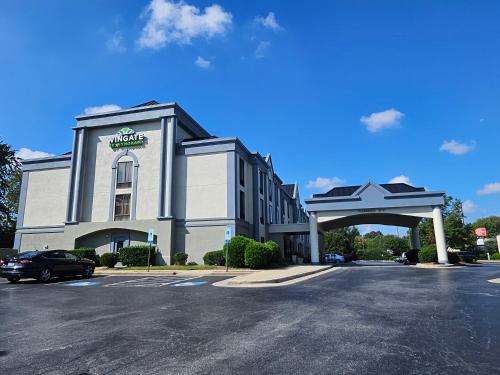 a building with a car parked in front of it at Wingate by Wyndham Greensboro-Coliseum in Greensboro