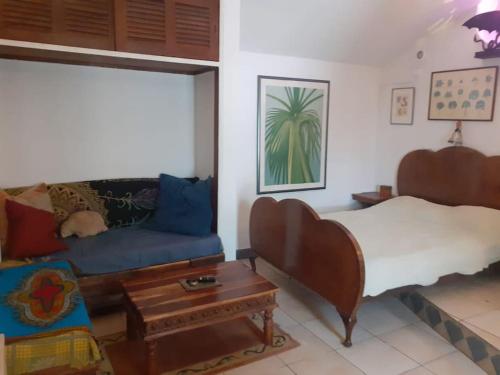 a living room with a bed and a couch at Bica da Salema Beach House in Salema