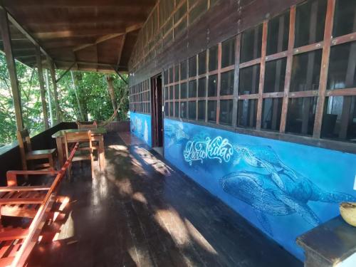 a restaurant with a mural of a fish on the wall at Pirate Drake Beach Camp & Tour company in Drake