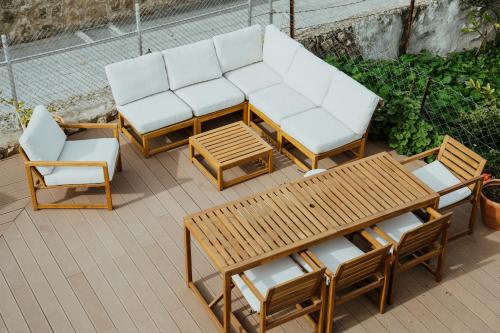 a group of chairs and tables on a patio at Sotiris House in Kazaphani