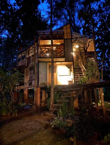 a house with stairs leading up to it at night at Monsamkien Farmstay in Phayao