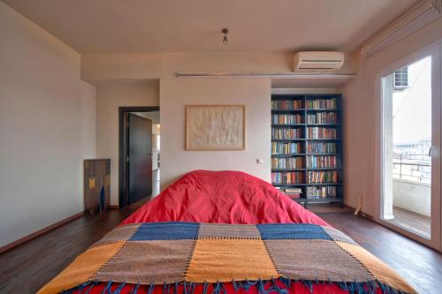 a bedroom with a bed with a colorful blanket at Sofia center best view in Sofia