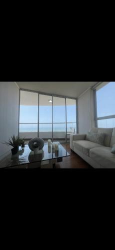 利馬的住宿－Panoramic Condominio，客厅配有白色的沙发和桌子