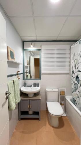 a bathroom with a toilet and a sink at Casa Pez in Ayamonte