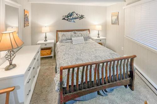 a bedroom with a bed and two tables and two lamps at Timber Ridge C7 in Sugar Mountain