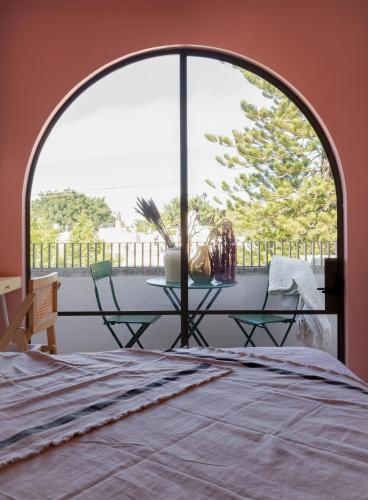 a room with a bed and a table and a window at Casa España in Guadalajara