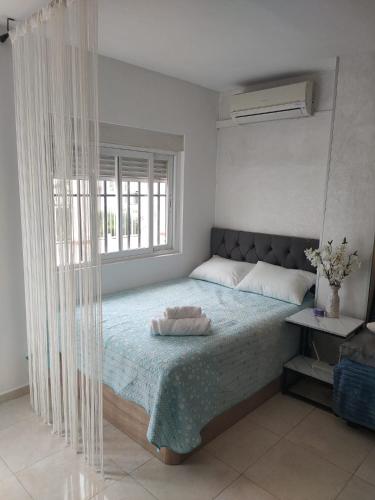 a bedroom with a large bed with a window at Casa Playa de la Mata in La Mata