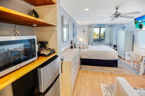 a bedroom with a bed and a flat screen tv at Tranquil 3rd Flr Resort View King Room in Pawleys Island