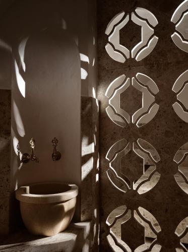a bathroom with a toilet and a wall at Pierros Verde in Lithakia