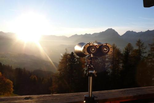 a camera on a tripod on top of a mountain at Biohotel Grafenast in Pill