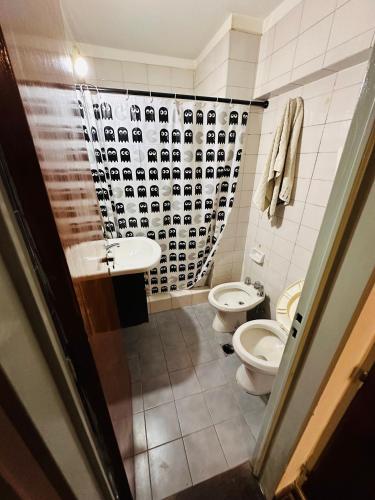 a bathroom with two toilets and a sink at Refugio Urbano in Cordoba