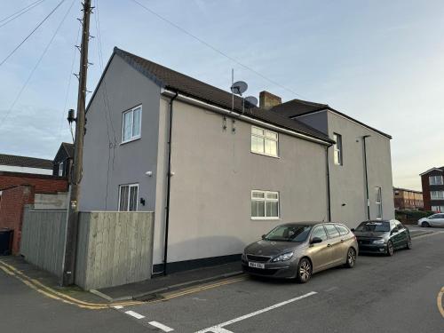 a house with two cars parked in front of it at Coatham house in Redcar