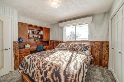 a bedroom with a bed and a desk and a window at Idaho Vacation Rental Day Trip to Yellowstone! in Sugar City