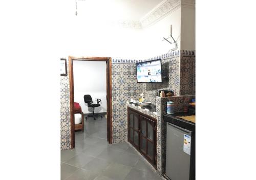 a kitchen with a mirror and a room with a chair at Apartment in Safi Fantastic Near the sea, Morocco in Safi