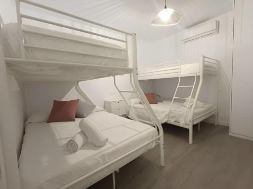 two bunk beds in a small room with a bed at City Castle, Granada center, casa completa in Granada