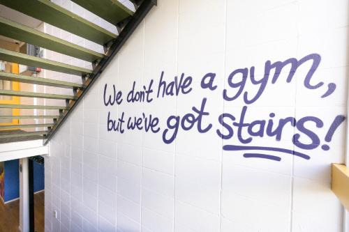 a wall with a sign that says we dont hate a gym but weve got at Urban Lounge Sleepery in Rotorua