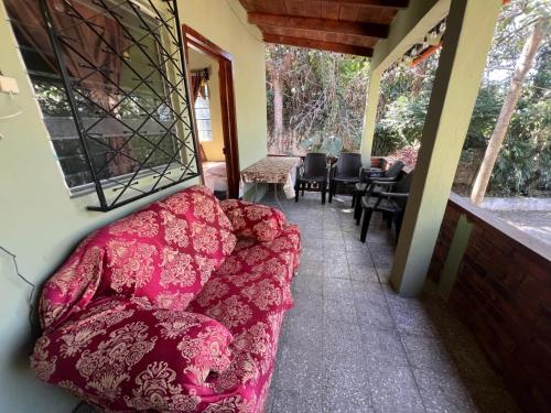 a couch sitting on the porch of a house at Cabaña de Atitlan in Panajachel