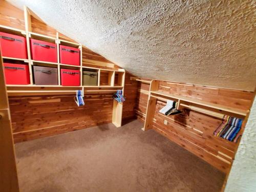 a room with wooden walls and cabinets with red drawers at Juneau Cabin near Eaglecrest & Trails in Juneau