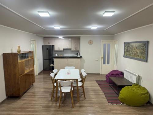 a kitchen and a dining room with a table and chairs at The View Apartments in Yerevan