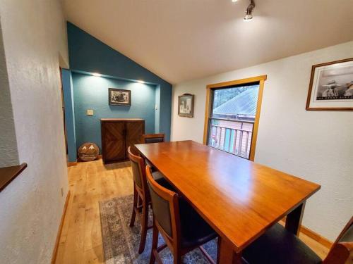 a dining room with a wooden table and chairs at Cabin & A-Frame w/ Firepit near Fishing & Trails in Juneau
