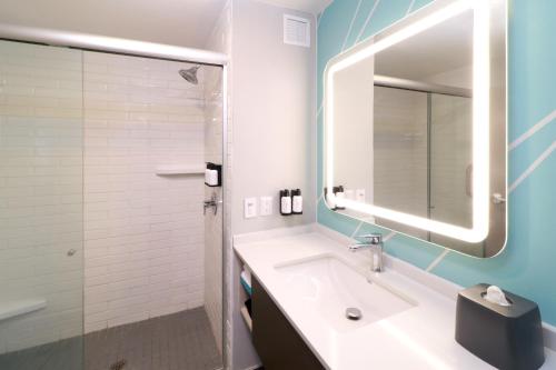 a bathroom with a sink and a mirror at avid hotels - Tijuana - Otay by IHG in Tijuana